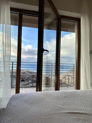 a bedroom with a bed and a view of the ocean at N Lux 81 - Milmari Resort in Kopaonik