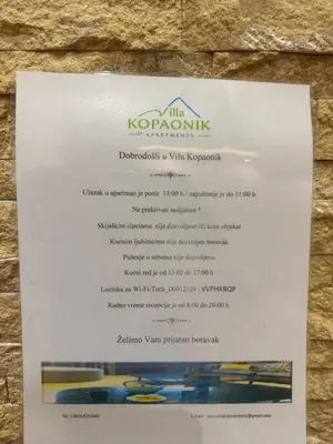 a menu for the kokoinian restaurant on a wall at Vila Kopaonik Apartmani Milenkovic in Kopaonik