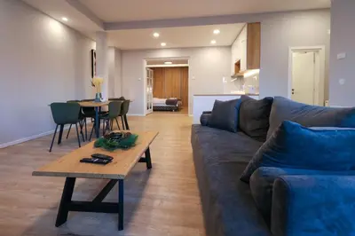a living room with a couch and a table at Heart of Niš Lux in Niš