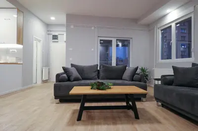 a living room with a couch and a coffee table at Heart of Niš Lux in Niš