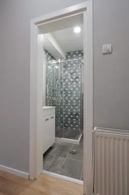 a bathroom with a shower with a glass door at Heart of Niš Lux in Niš