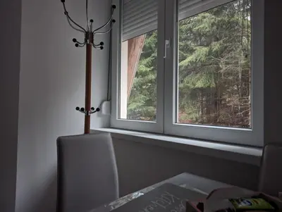 a room with a window with a chair and a table at Kod Strica in Kopaonik
