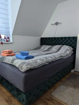 a bed with two towels on it in a room at Kod Strica in Kopaonik