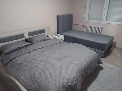 a bedroom with a bed and a bench in it at Rajna in Pirot