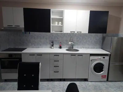 a kitchen with a sink and a washing machine at Rajna in Pirot