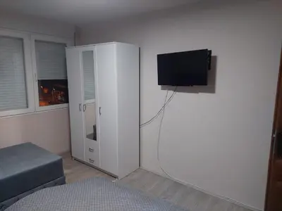 a bedroom with a white cabinet with a flat screen tv at Rajna in Pirot