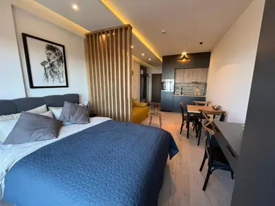 a bedroom with a blue bed and a dining room at Milmari resort Nlux21 in Kopaonik