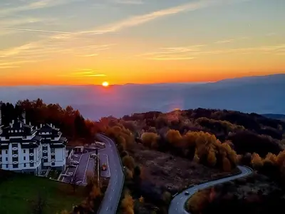 arial view of a house and a road at sunset at Milmari resort Nlux21 in Kopaonik