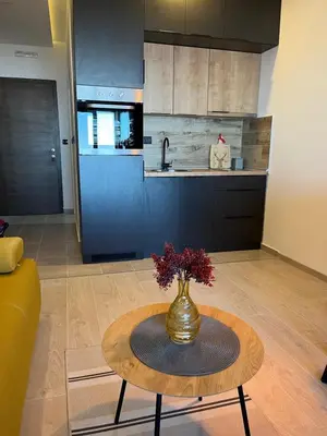 a kitchen with a table with a vase on it at Milmari resort Nlux21 in Kopaonik
