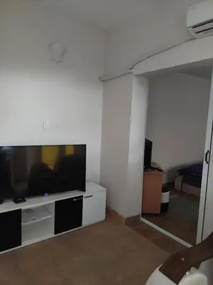 a living room with a flat screen tv and a couch at Comfort in Pirot