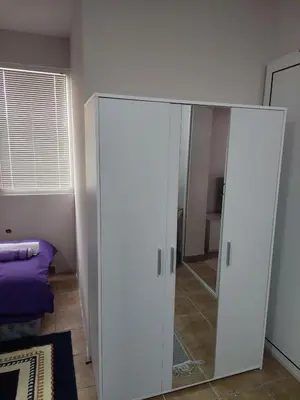 a white closet with a mirror in a room at Comfort in Pirot