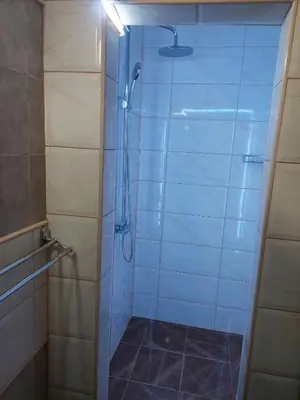 a shower with a glass door in a bathroom at Comfort in Pirot