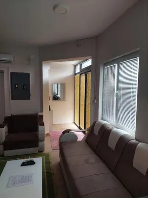 a living room with a couch and a table at Comfort in Pirot
