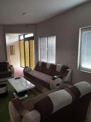 a living room with a couch and a table at Comfort in Pirot