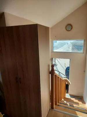 a room with a staircase with a window and a door at ASTRA in Pirot