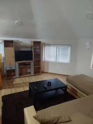 a living room with a couch and a coffee table at ASTRA in Pirot