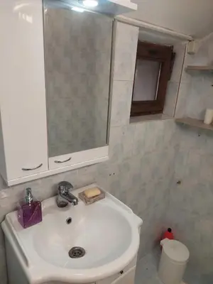 a bathroom with a white sink and a mirror at ASTRA in Pirot