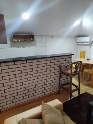 a room with a bar with a chair and a table at ASTRA in Pirot