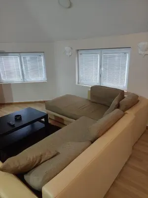 a large couch in a living room with windows at ASTRA in Pirot