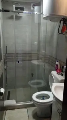 a bathroom with a shower with a toilet and a sink at M Central Park in Niš
