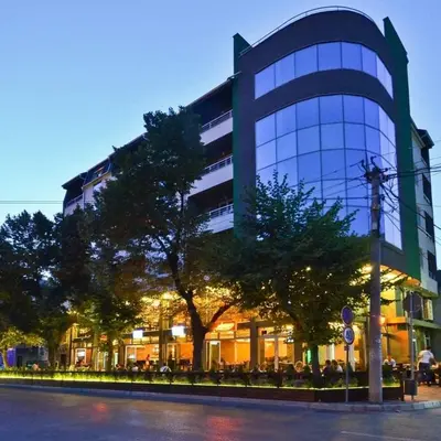a large glass building with trees in front of it at M Central Park in Niš