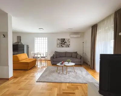 a living room with a couch and a table at Apartmani TEO in Prokuplje