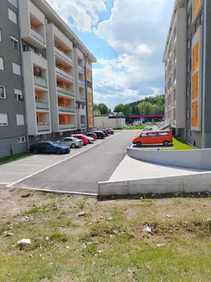 a parking lot with cars parked in front of buildings at Apartman Branković Pirot-Zapadni Kej 58 in Pirot