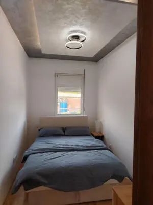 a bedroom with a bed and a window at Apartman Branković Pirot-Zapadni Kej 58 in Pirot
