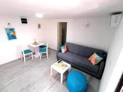 a living room with a couch and a table at Apartman Mata in Soko Banja
