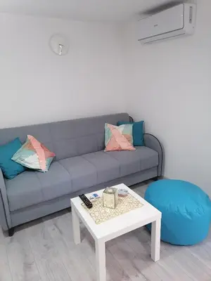 a living room with a couch and a coffee table at Apartman Mata in Soko Banja