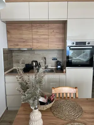 a kitchen with a table with a vase on it at Apartmani NLUX and SPA in Kopaonik