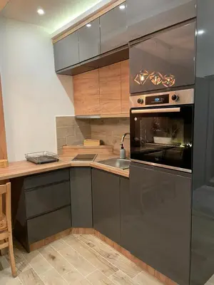 a kitchen with a sink and a stove top oven at Apartmani NLUX and SPA in Kopaonik