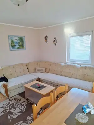 a living room with a couch and a table at Kraljevi čardaci Čar 3 in Kopaonik
