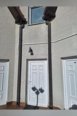 a building with two doors and a shadow of a bat at Kraljevi čardaci Čar 3 in Kopaonik