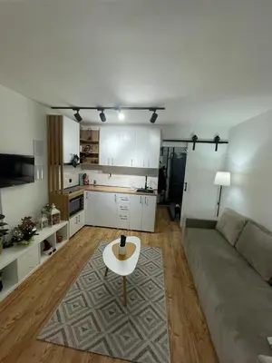 a living room with a couch and a table at Apartman Element in Kruševac