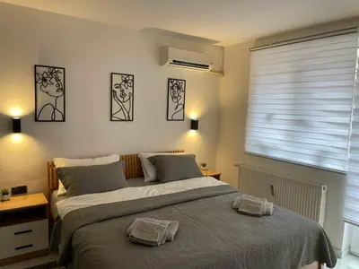 a bedroom with a bed with two towels on it at Apartman Afrodita Lux 1 in Niš