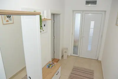 a room with white walls and a door and a table at Vila Harmony in Pirot