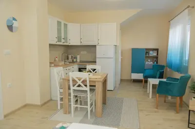a kitchen and dining room with a table and chairs at Vila Harmony in Pirot