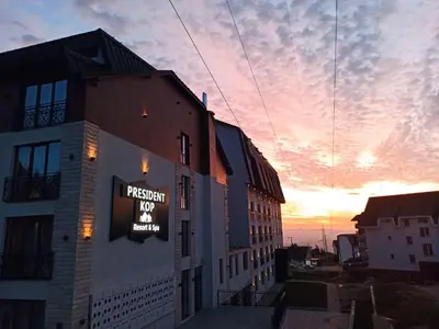a building with a sign on the side of it at President Kop Apartman A843 in Kopaonik