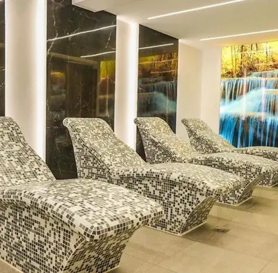 a group of chairs sitting in a room at President Kop Apartman A843 in Kopaonik