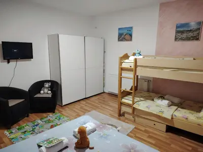 a small room with two bunk beds and a couch at Apartman Raj in Vrnjačka Banja