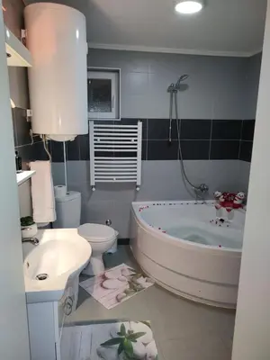 a bathroom with a tub and a toilet and a sink at Apartman Raj in Vrnjačka Banja