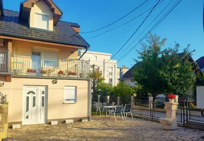 a house with a patio and a table and chairs at Apartman Raj in Vrnjačka Banja