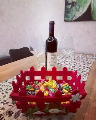 a bottle of wine and two wine glasses on a table at Suncana Planina Glory-Kop in Kopaonik
