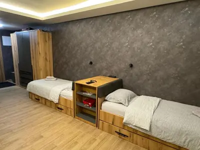 a bedroom with two beds and a wall at Suncana Planina Glory-Kop in Kopaonik