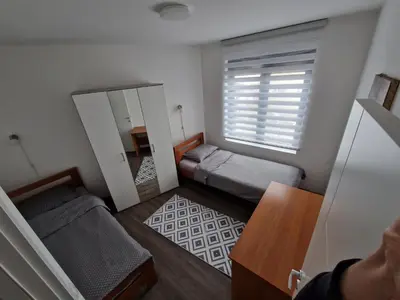 a small room with two beds and a mirror at Apartman Paradiso in Pirot