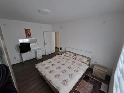 a small bedroom with a bed and a television at Apartman Paradiso in Pirot