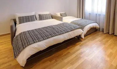 two beds sitting next to each other in a bedroom at Apartman Jelka Brzece in Brzeće