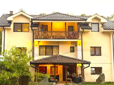a house with a balcony on top of it at Apartman Vrh 88 in Vrnjačka Banja