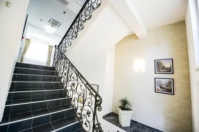 a staircase in a house with black tiles at Vila Palas in Vrnjačka Banja